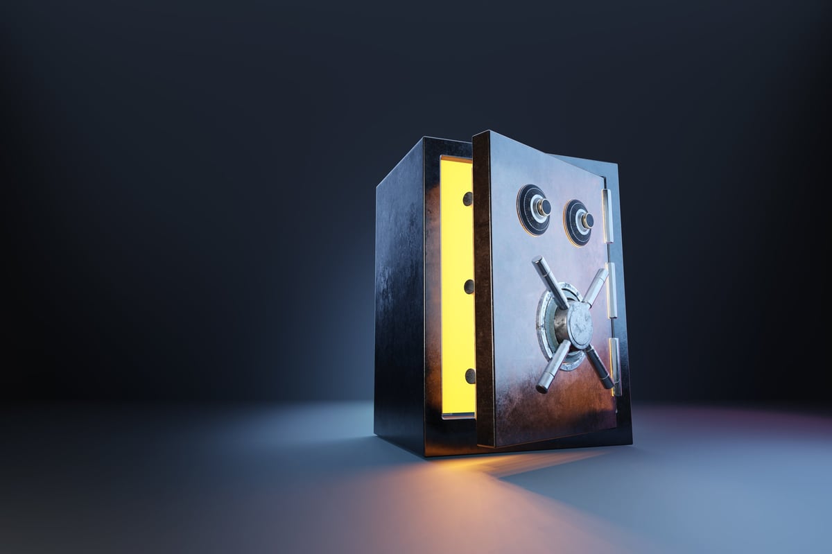 Slightly opened bank vault leaking golden ray of light on dark background. Illustration of wealth and prosperity