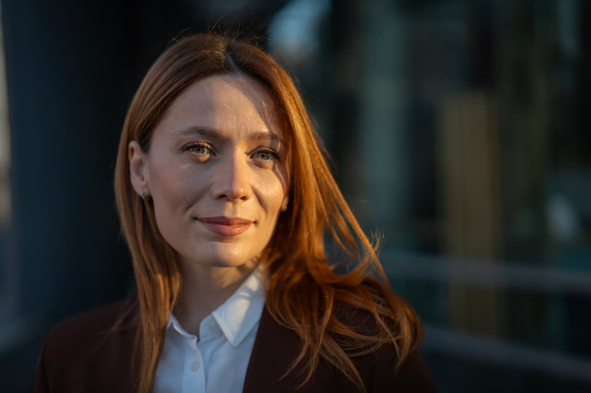 Professional portrait of a confident businesswoman in warm golden light