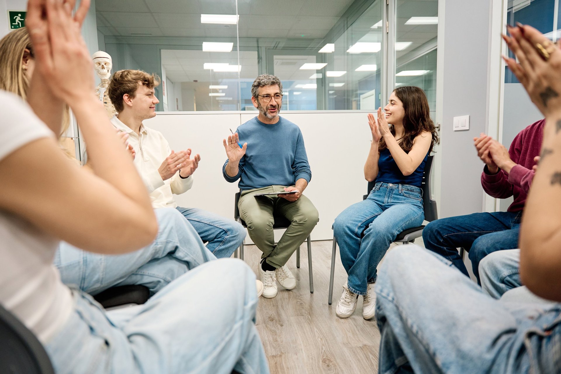 Facilitator leading a group session, guiding participants in a circle